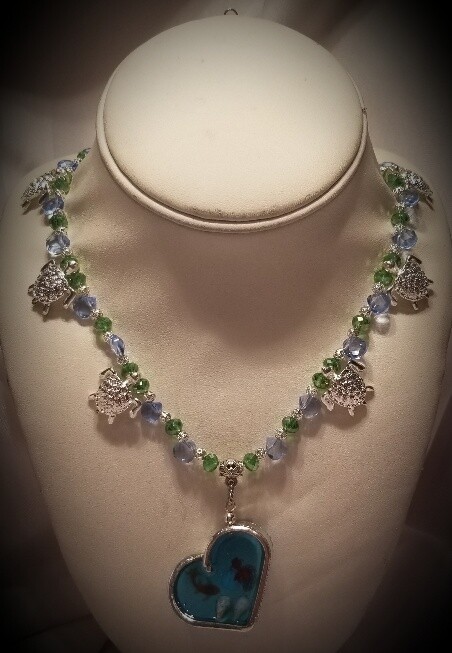 Turtle necklace with silverware heart.