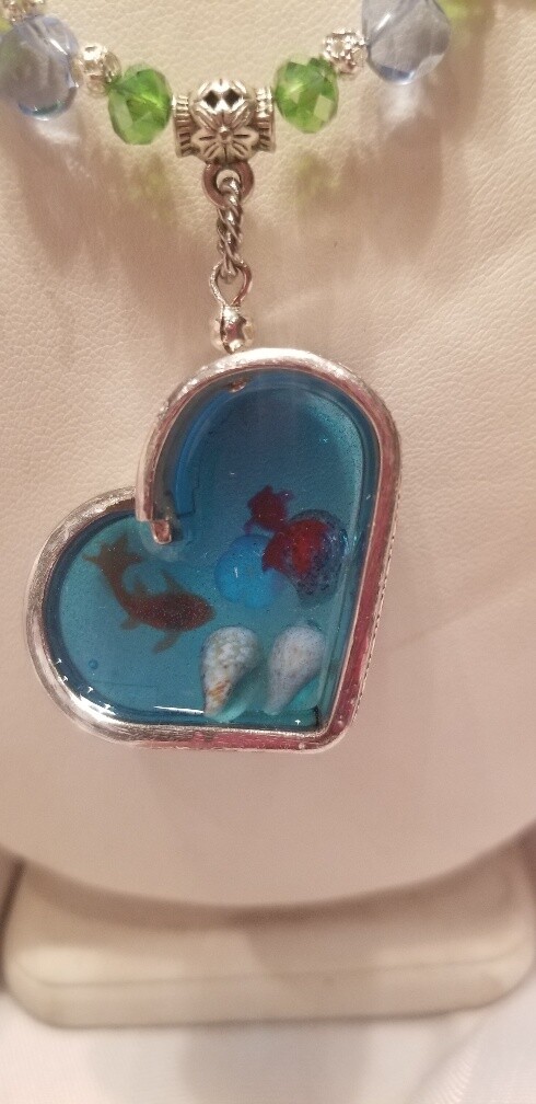 Turtle necklace with silverware heart.