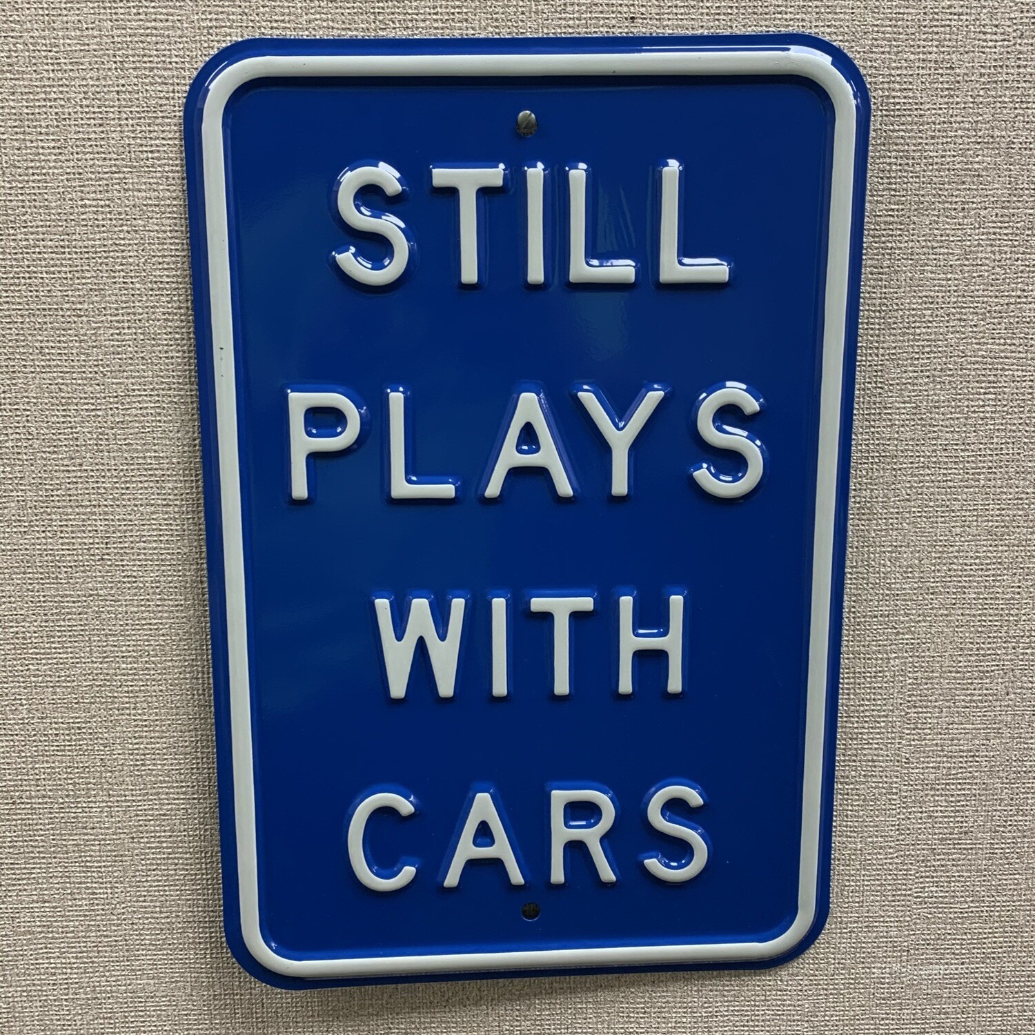 " Still Plays With Cars" Metal Sign 