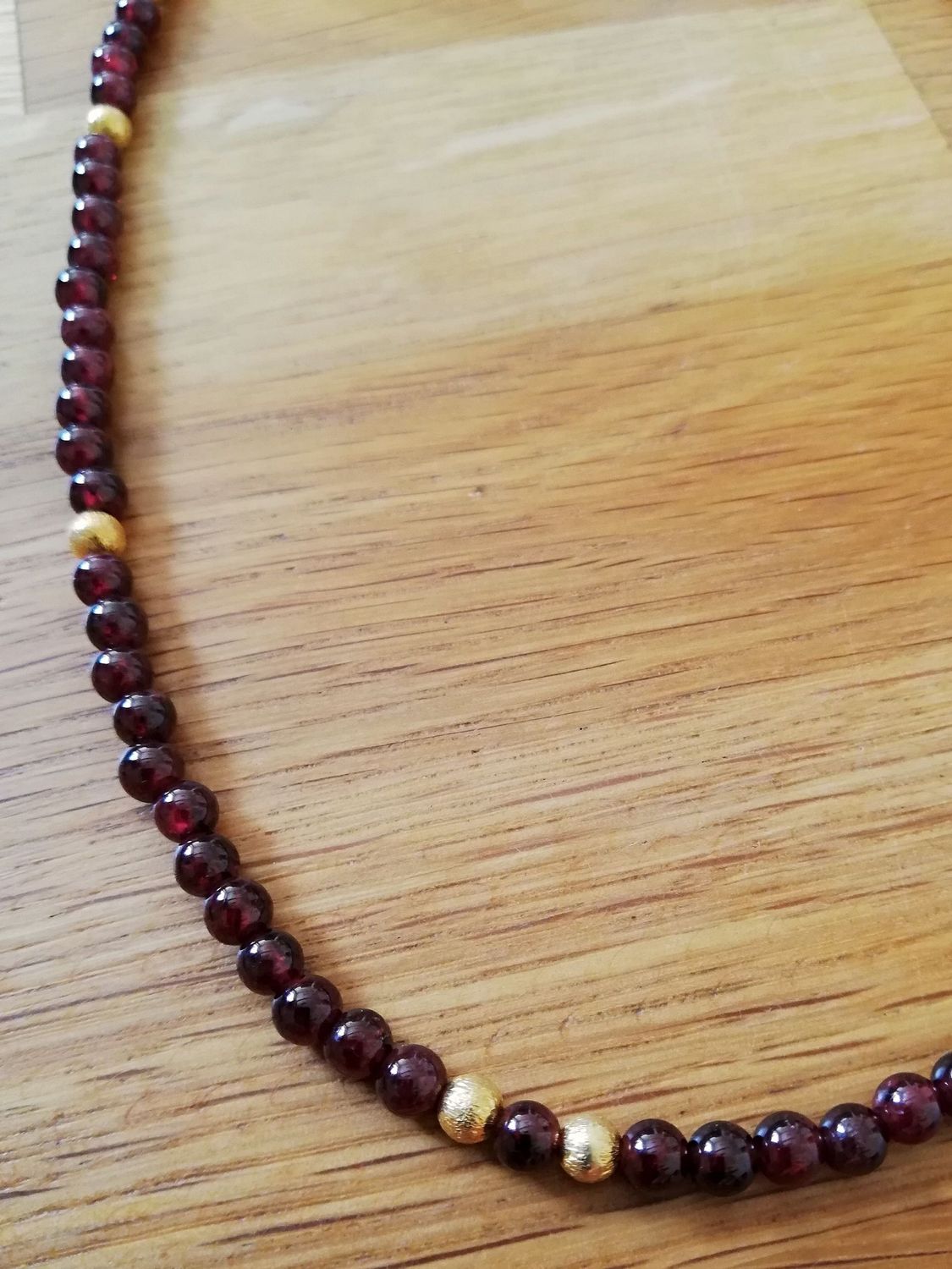 circa 45 cm lange Kette: roter Granat mit Zwischensteilen aus vergoldetem Silber