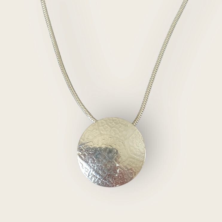 Leaf vein disc pendant by Margaret Rae
