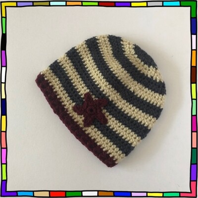 "Children's storm blue and cream striped crochet beanie hat decorated with a burgundy star motif"