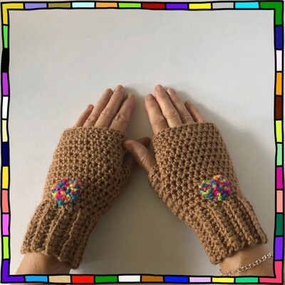 "Women's camel colour hand crocheted fingerless gloves which are decorated with small rainbow heart motifs"