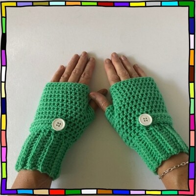 "Women's mint green hand crocheted fingerless gloves which are adorned with matching strips and white buttons"