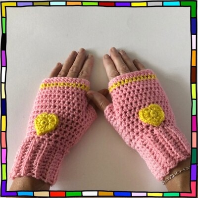 "Women's pink hand crocheted fingerless gloves which feature a single yellow stripe at the top and yellow heart motifs on the front" 