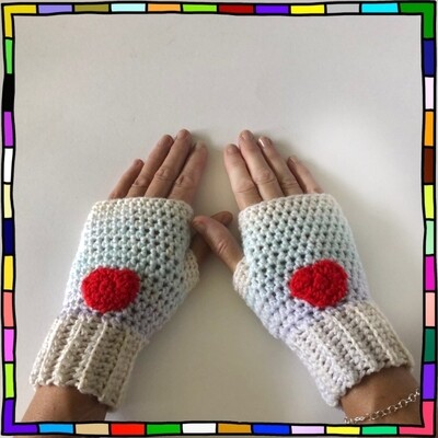 "Women's pastel shades hand crocheted fingerless gloves which are adorned with red heart motifs on the front"