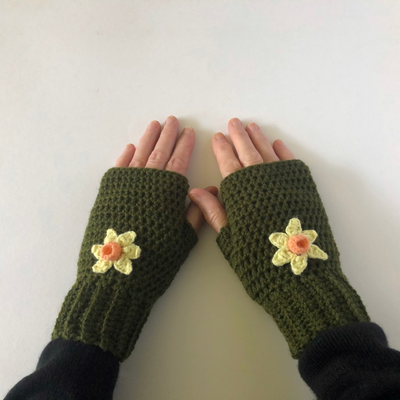 "women's dark green crochet fingerless gloves with daffodil motifs"