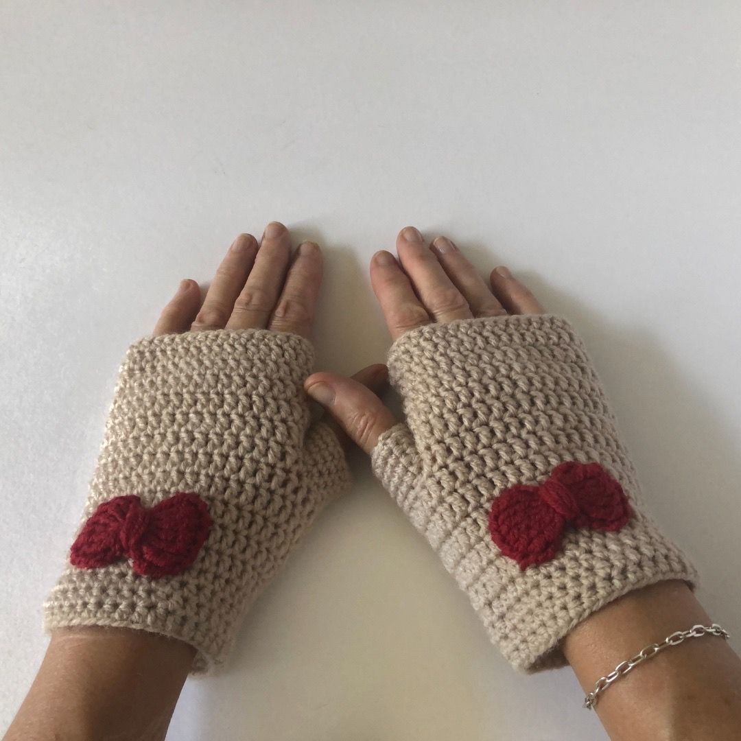 &quot;women&#39;s soft beige handmade crochet fingerless mittens, adorned with dark red crocheted bows&quot;