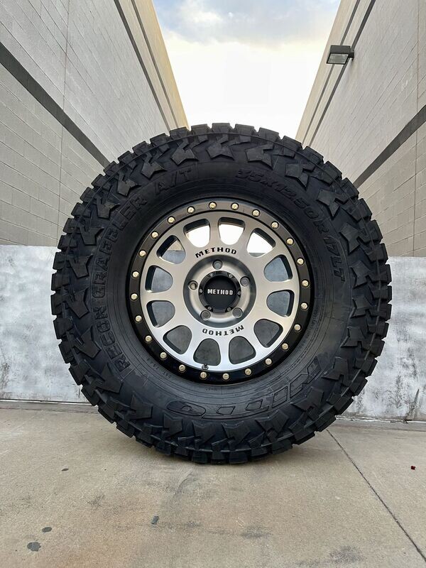 Wheel & Tire Method Race 17x8.5 5x139.7 Black Macine Face Wheels & 285-70-17 Nitto Recon Grappler A/T Tires