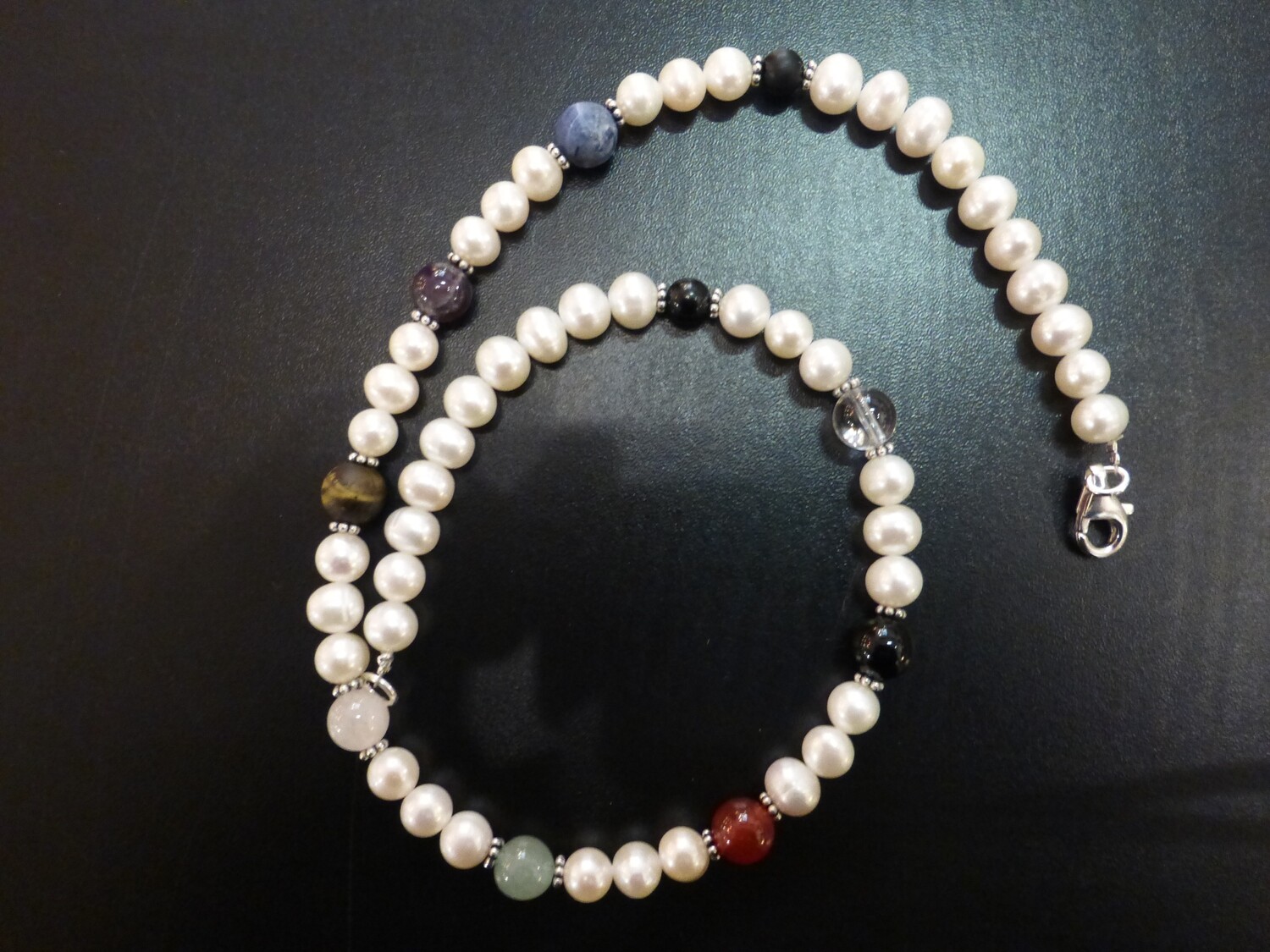 Collier tour de cou en perles d'eau douce, fleurs en argent et pierres des chakras. Longueur 44 cm