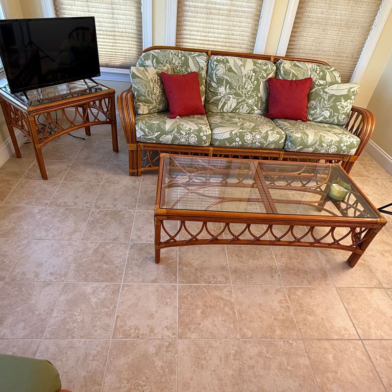 Antiqua natural rattan sofa 6'8 Antiqua natural rattan sofa 6'8"L x 27"D with thick floral leaf cream & sage cushions, glass-top end table 23"H x 28"L x 20"W & coffee table 16"H x 48"L x 24"D
