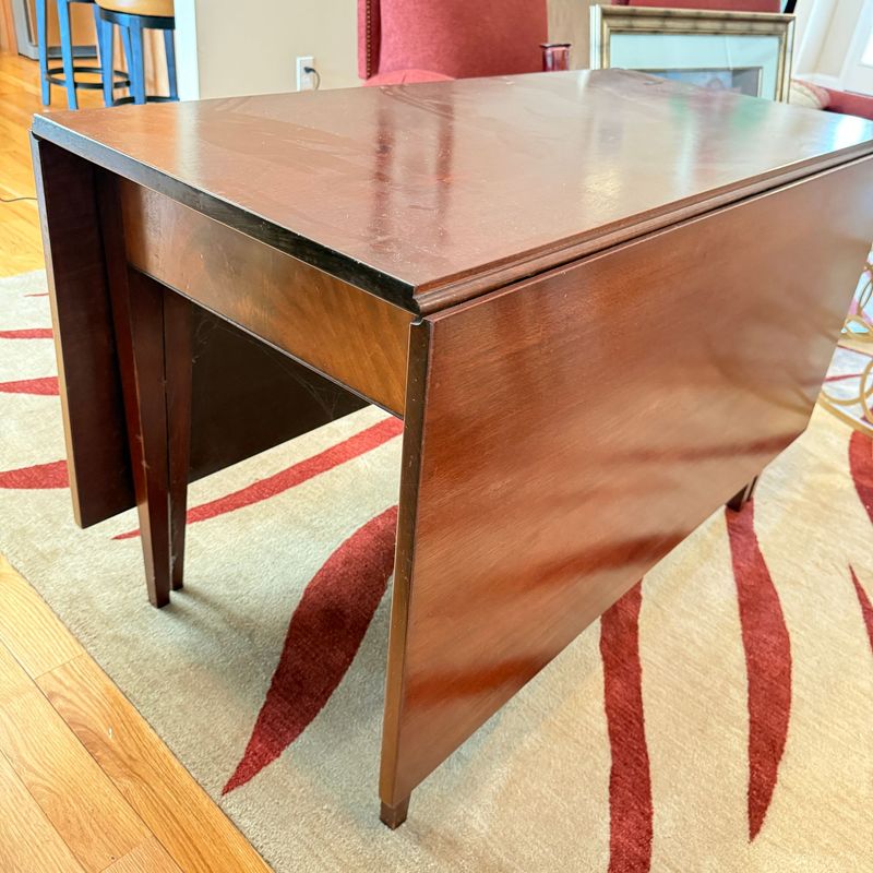 Large drop leaf dining table, has been professionally restored, does have some scratches 4'W with 22 Large drop leaf dining table, has been professionally restored, does have some scratches 4'W with 22" surface when closed, 5'7" when open