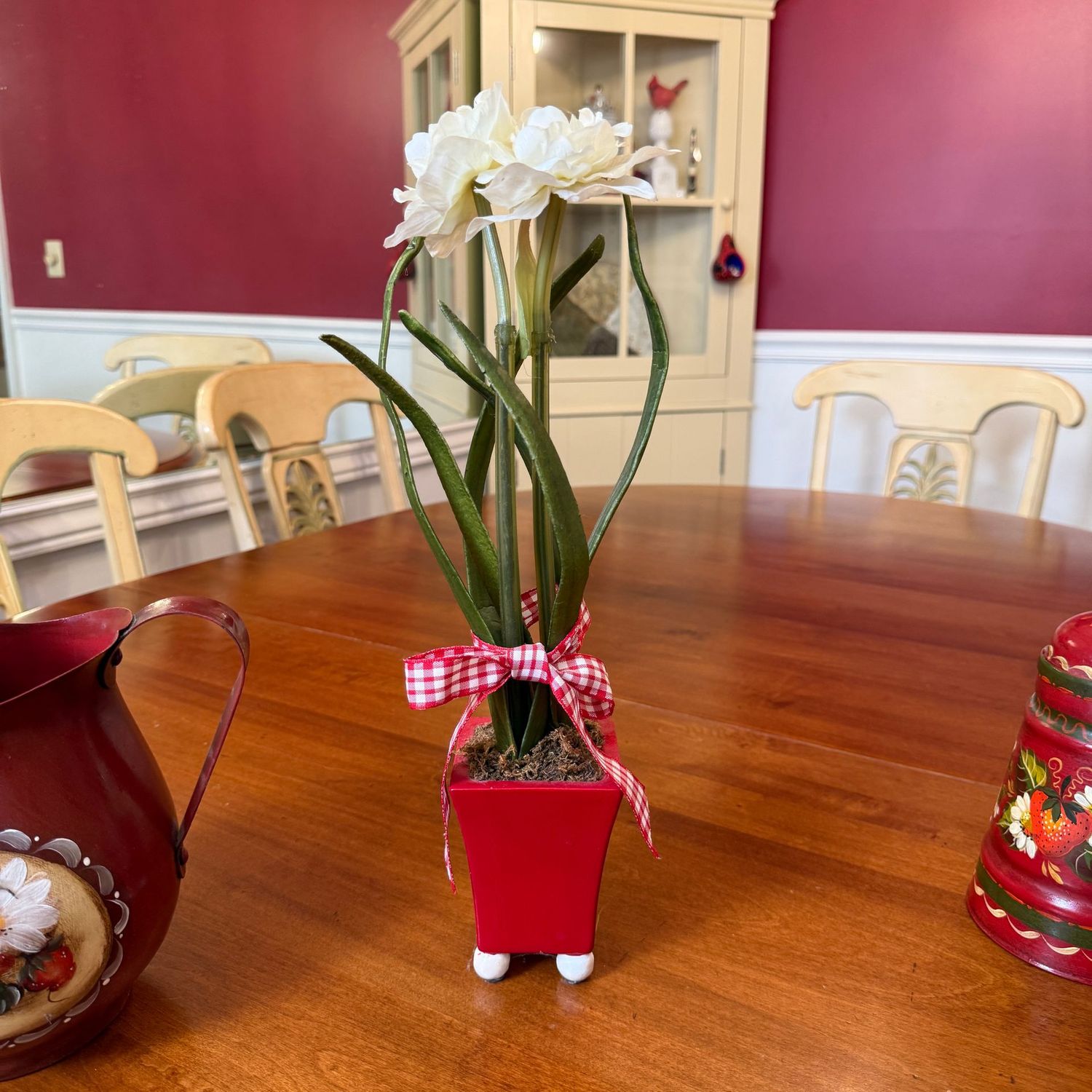 Faux white Amaryllis flowers in red ceramic planter on white ball feet 18"