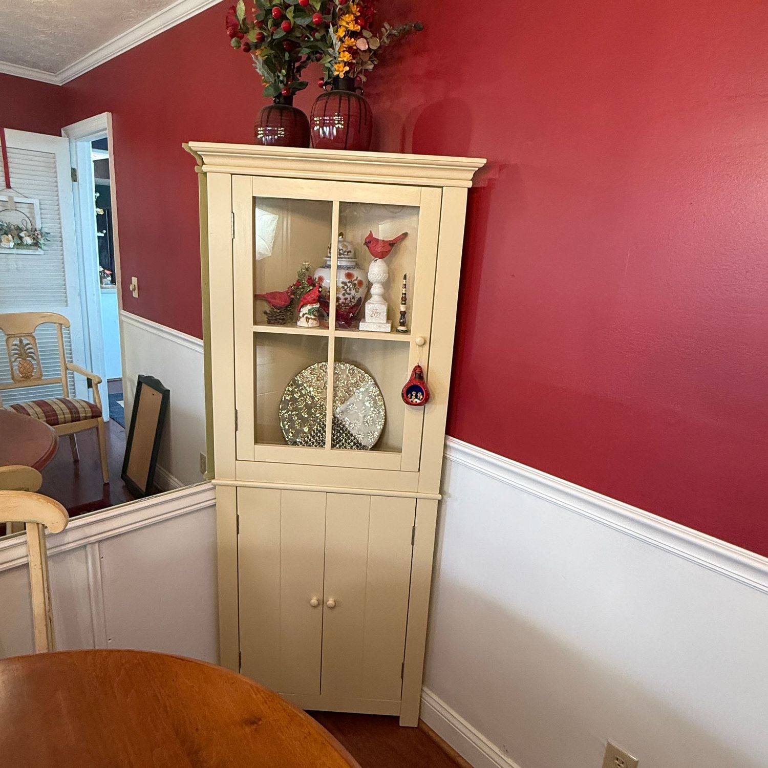 Corner cabinet with cream finish, glass upper door displays items beautifully, while double doors cover below, adjustable shelves 5'10"H x 26"W x 10"D