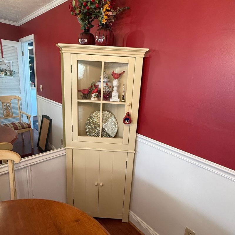 Corner cabinet with cream finish, glass upper door displays items beautifully, while double doors cover below, adjustable shelves 5'10 Corner cabinet with cream finish, glass upper door displays items beautifully, while double doors cover below, adjustable shelves 5'10"H x 26"W x 10"D