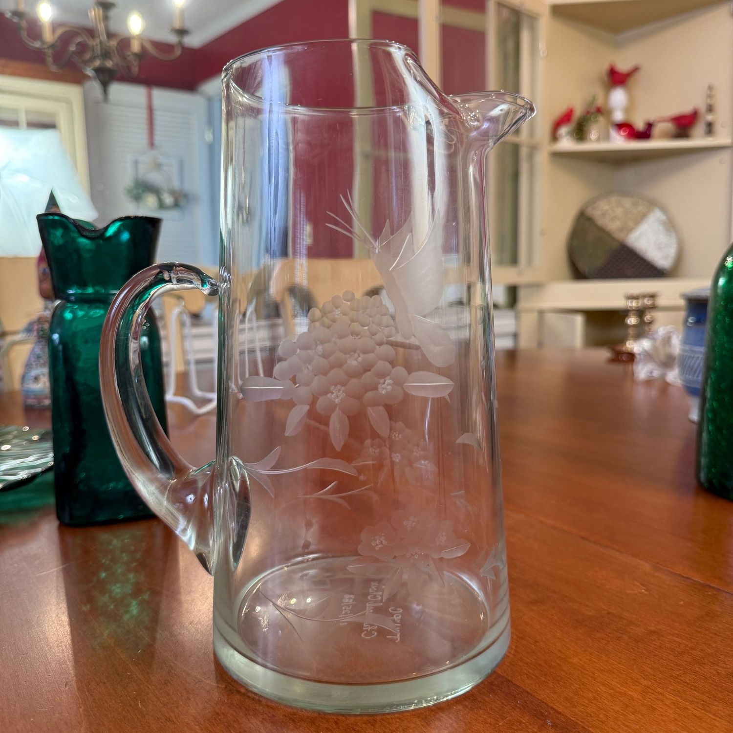 Clear glass pitcher with etched butterflies and flowers, marked TVPC Chancel Choir '83 on bottom 9"H