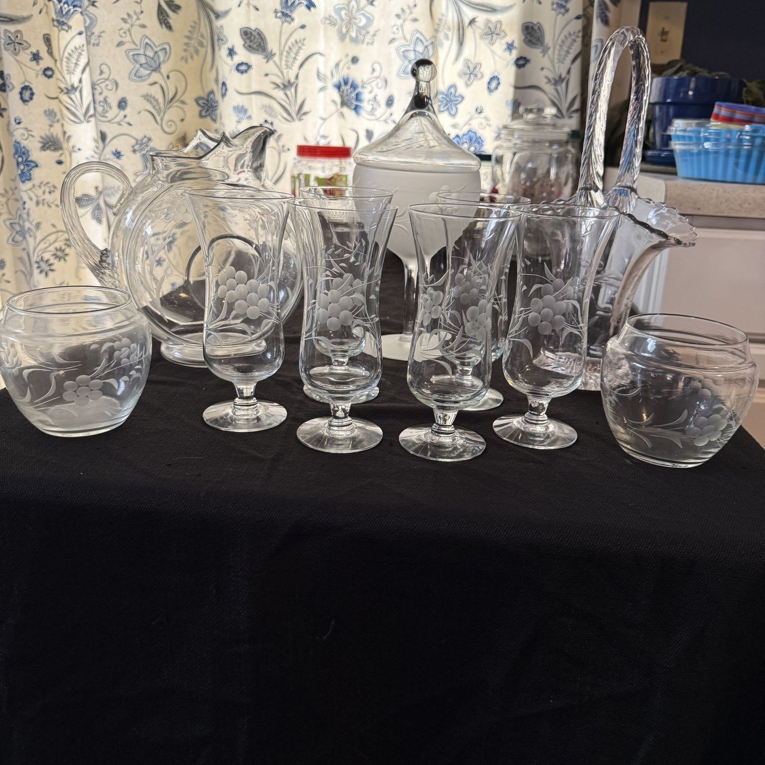 Group of clear glass with etched flowers, cocktail glasses, vases, pitcher, and basket