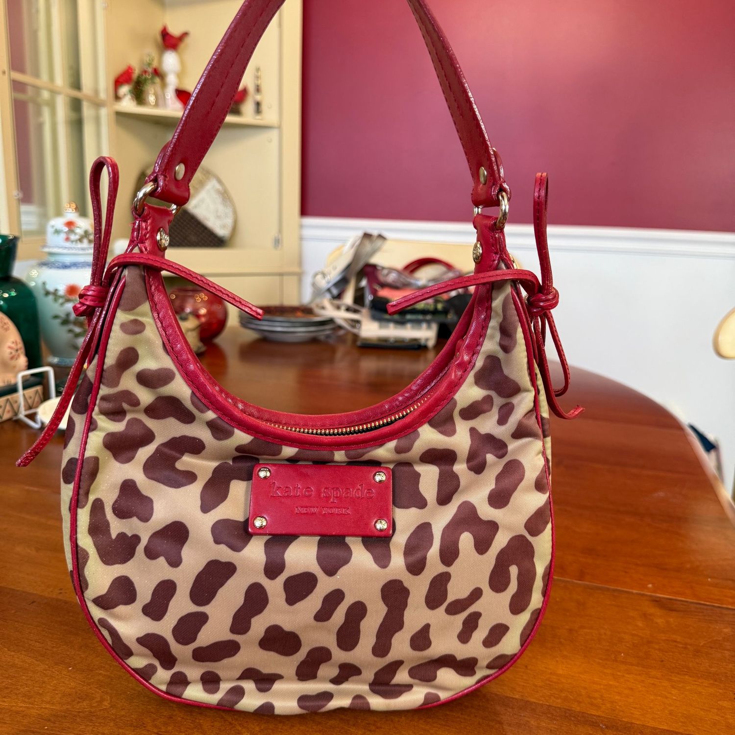 Leopard Kate Spade small purse with red patent leather strap and bows, minor wear 9"W x 9"H