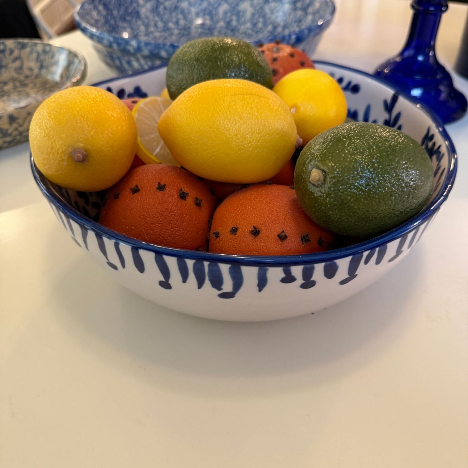 Belk Tabletops Gallery 10.5" blue and white ceramic bowl with faux fruit
