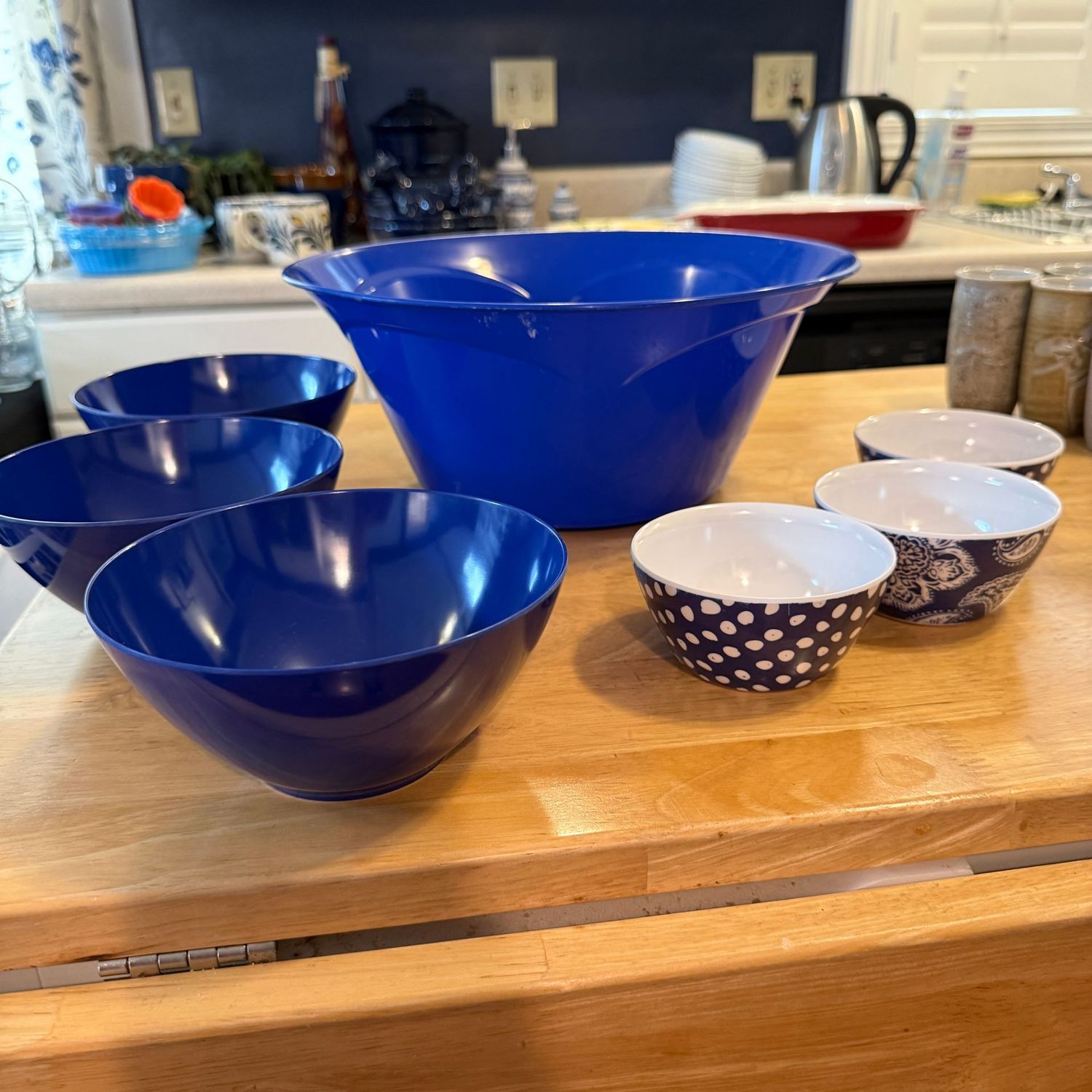 Group of blue plastic bowls, the largest is 13"