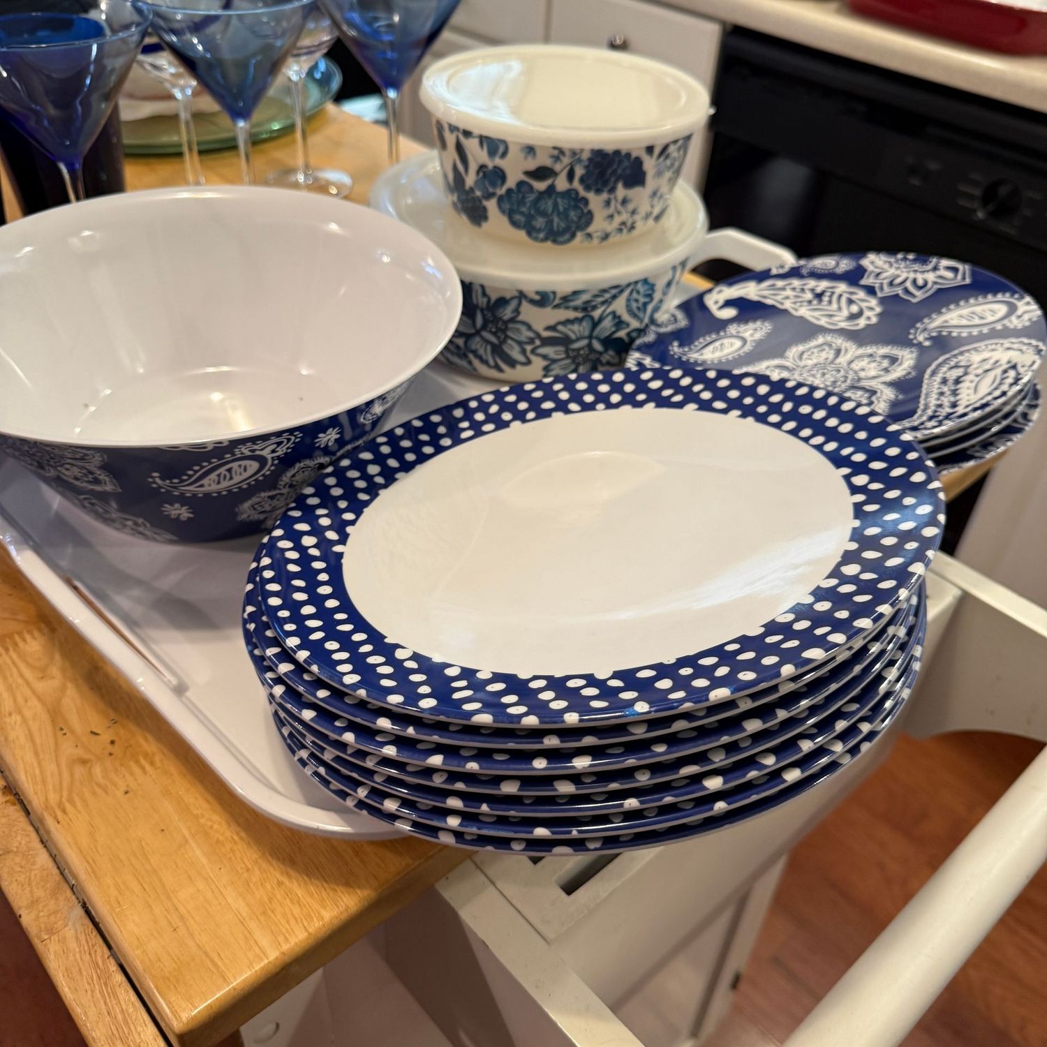 Blue and white plastic picnic plates, bowls, and 19"L white plastic tray