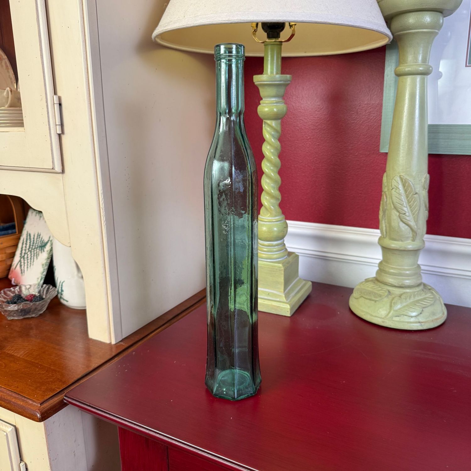 Slender green glass decorative paneled bottle 14"