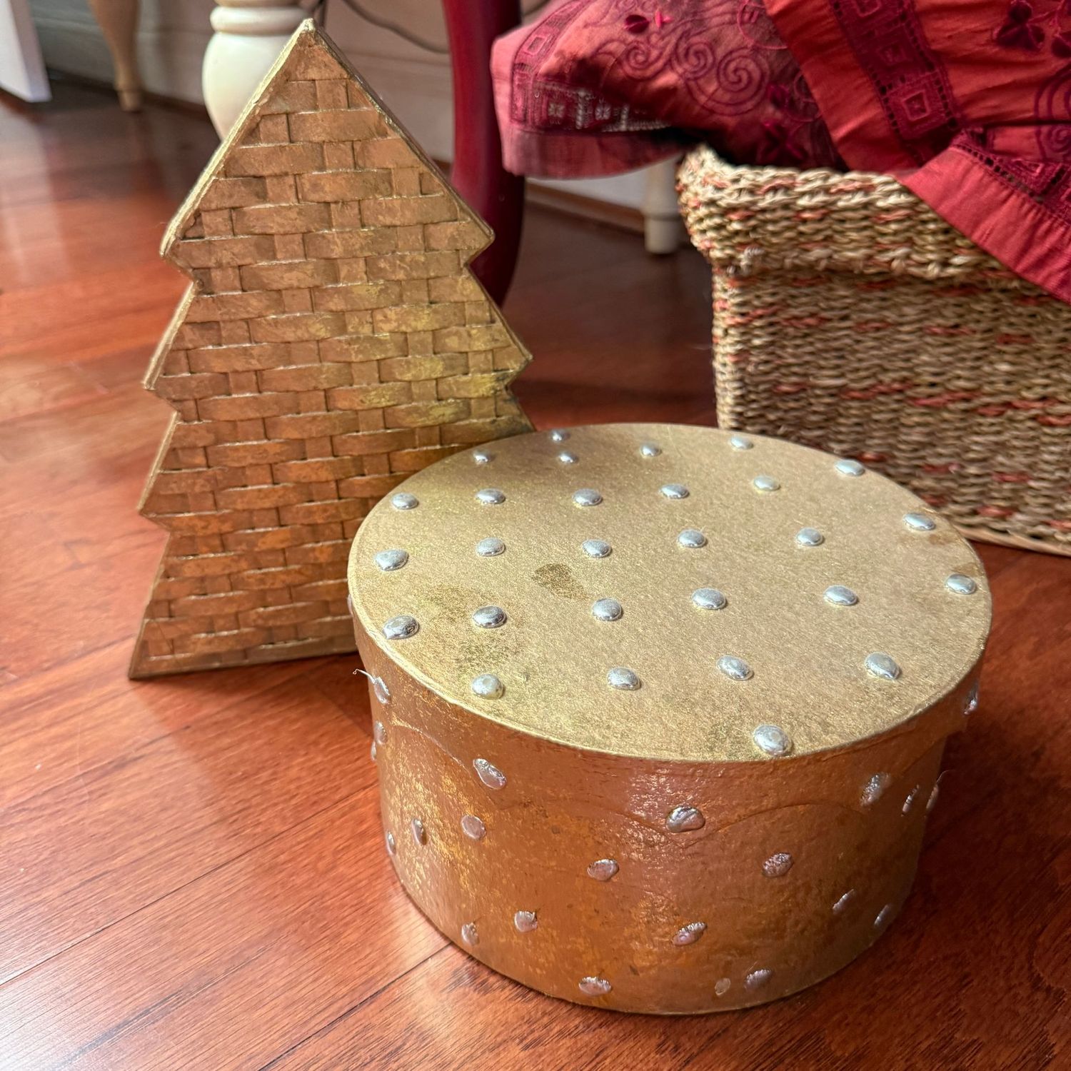 Two golden press board storage boxes, largest is 9"