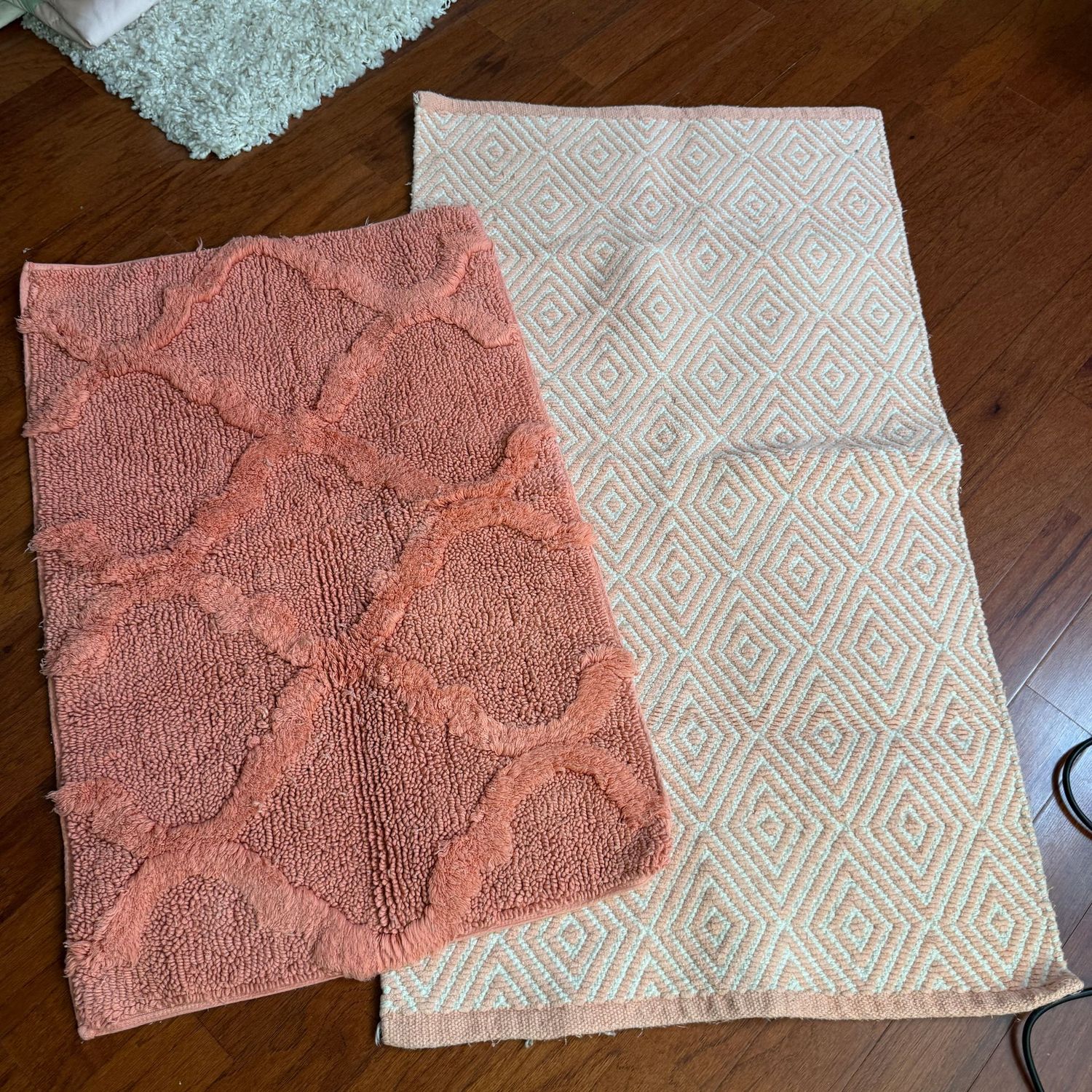 Peach throw rugs, soft, some wear, the largest is 40"L x 23"