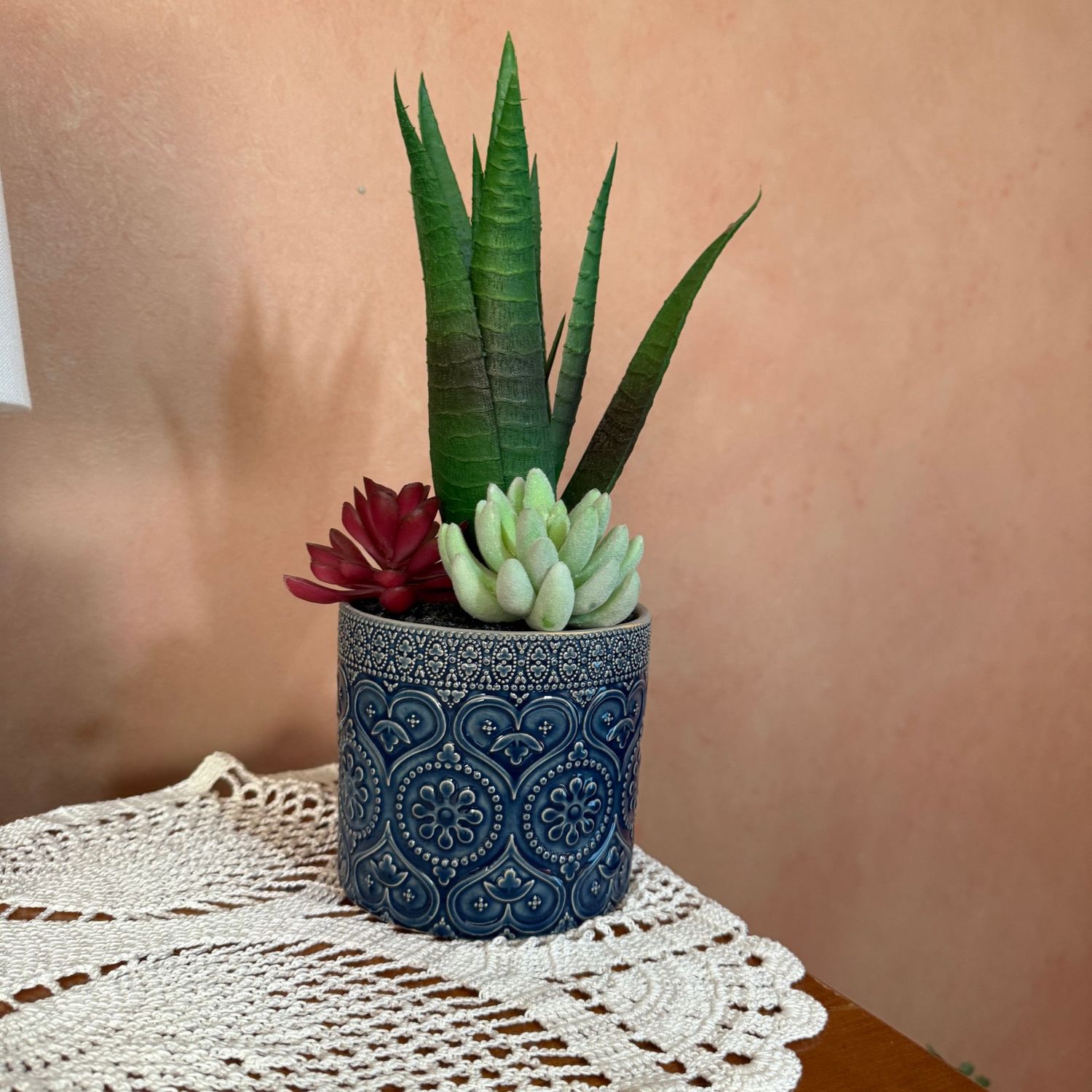 Blue planter with hearts and flowers, filled with faux plants 16"H