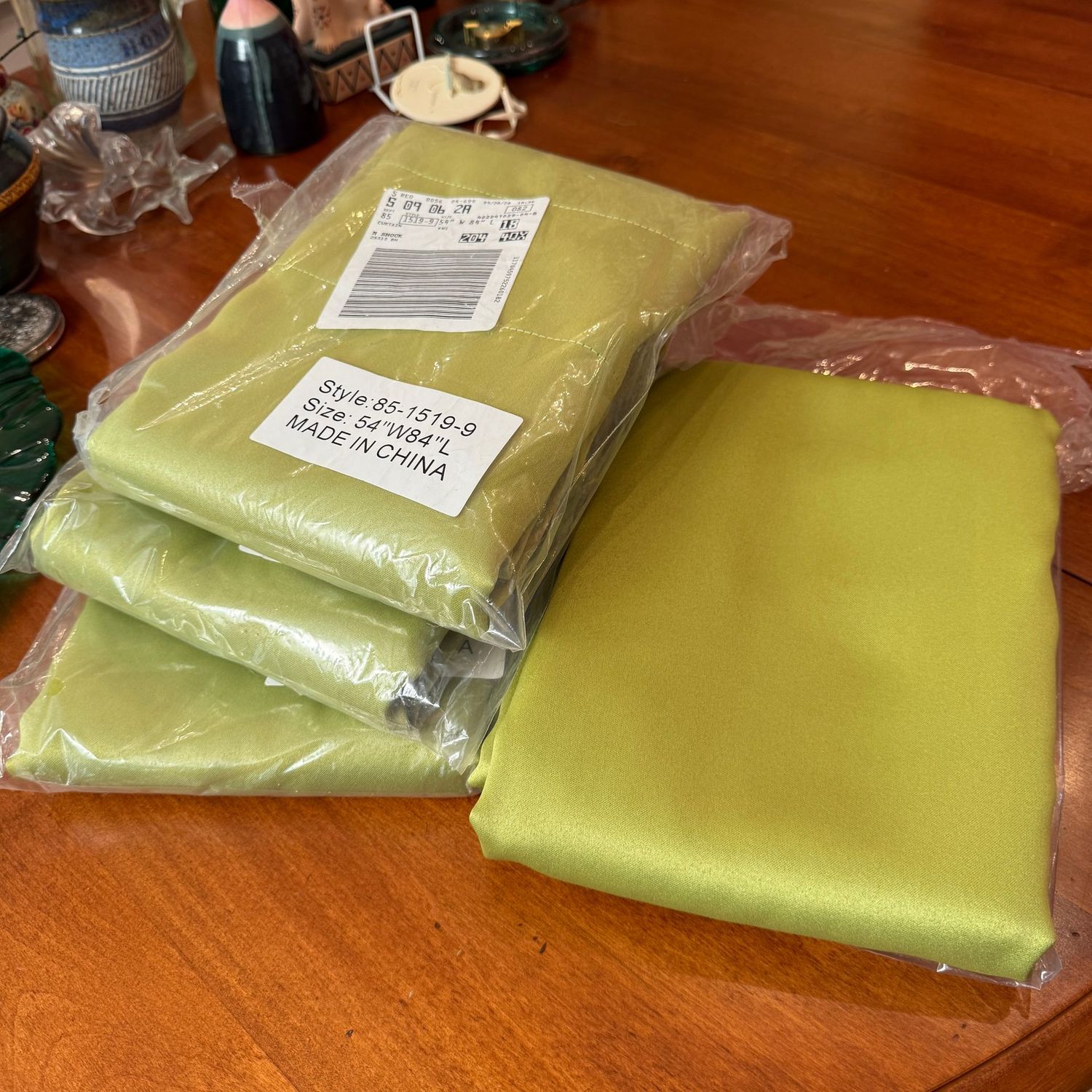 Four curtain panels, apple green satin, each are 54"W and 84"L with both narrow and wide rod pocket openings