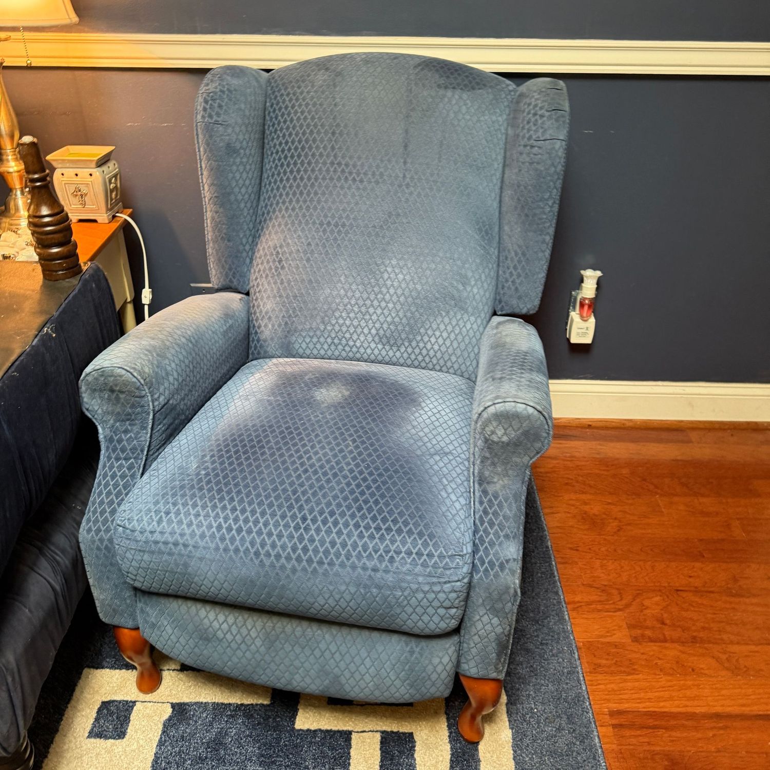 Blue recliner (R), needs surface cleaning, leg area shows wear, and back may need structural repair (leans a little to left when reclined) 36"H x 26"W