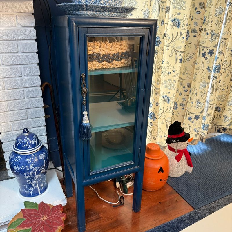 Blue wooden 3-shelf curio cabinet (likely Pier 1) 50"H x 19"W x 14"D