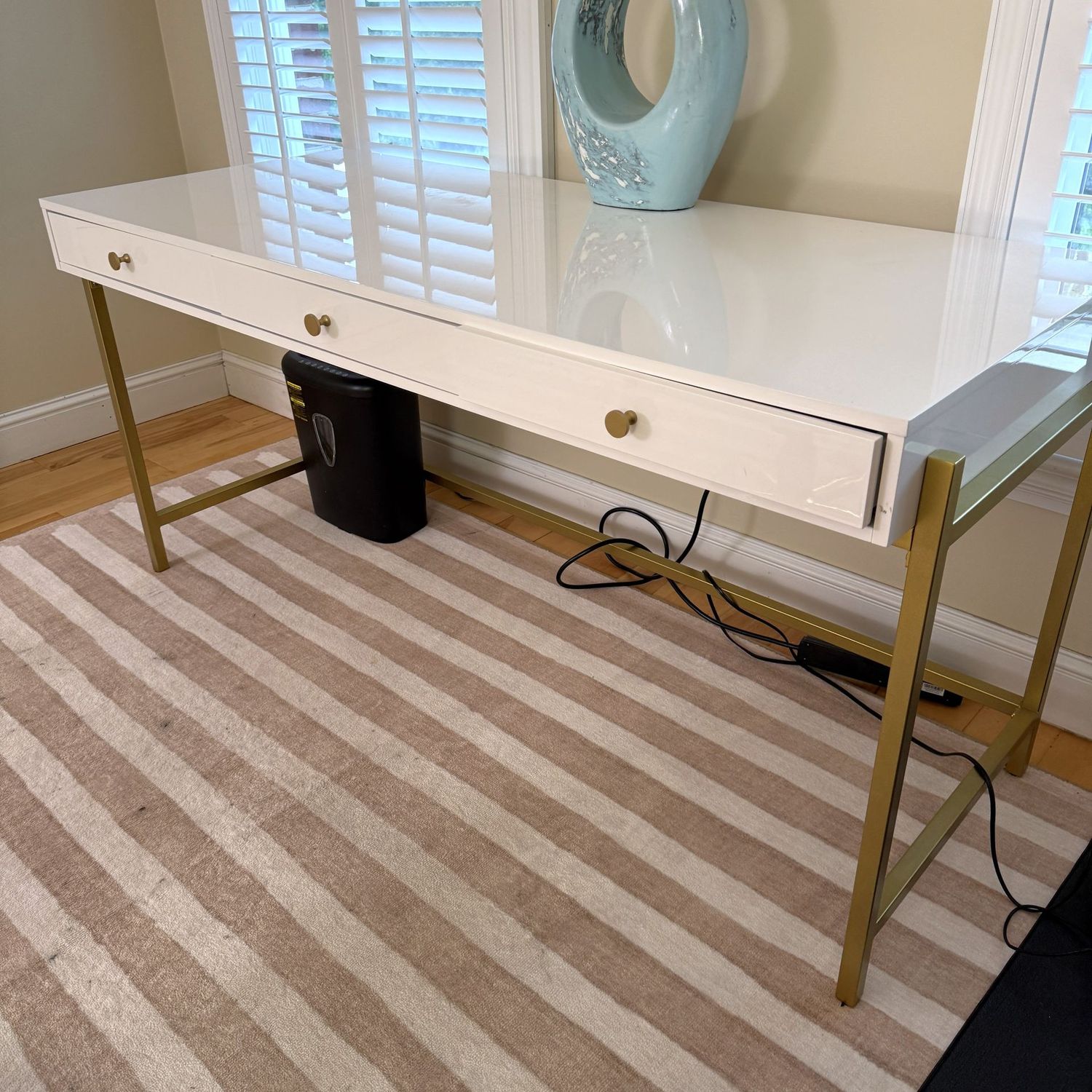 Rectangular desk with 3 drawers, glossy white finish, metal legs, center drawer sticks a touch, a few minor bumps, 25"D x 63"L