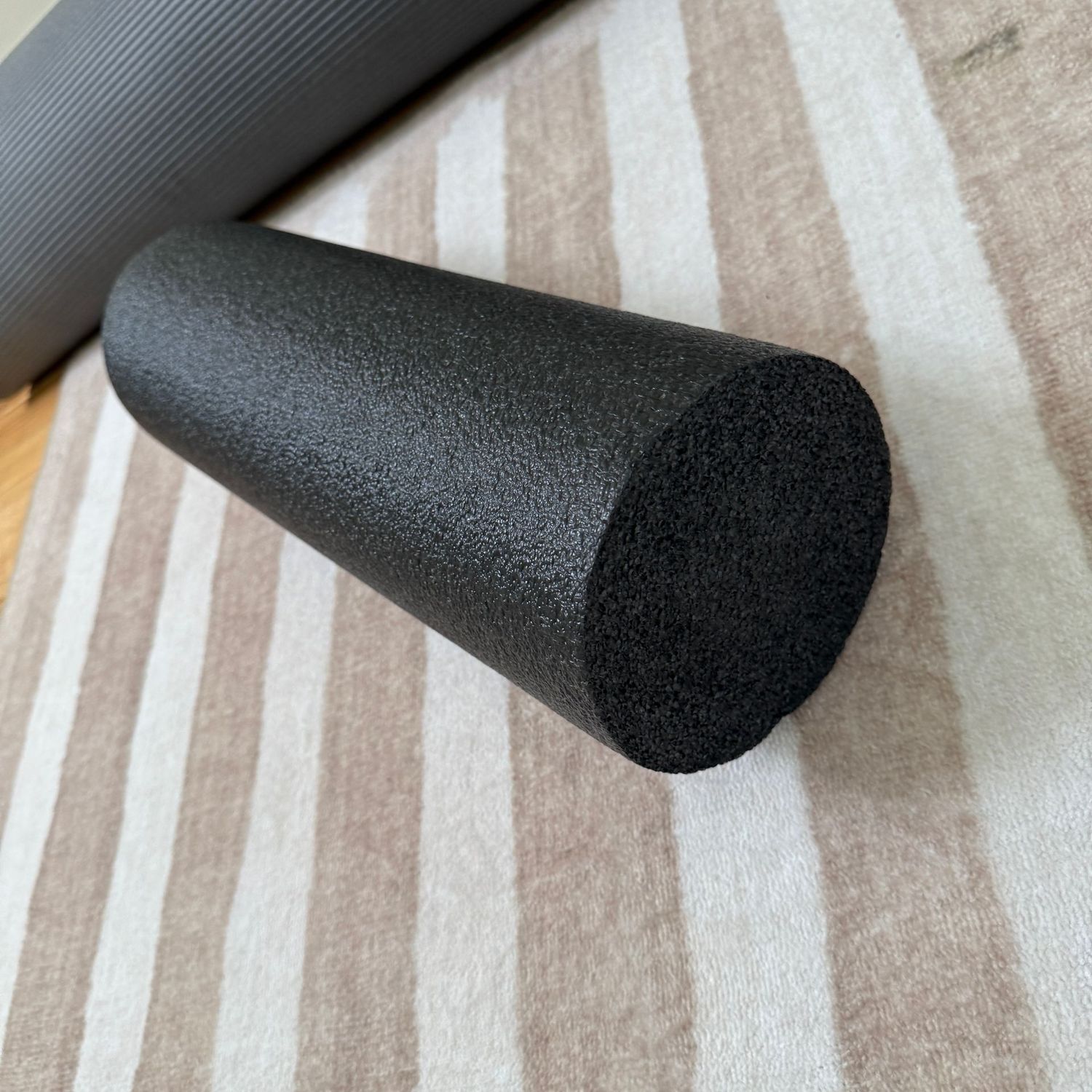Black 6" diameter firm exercise bolster