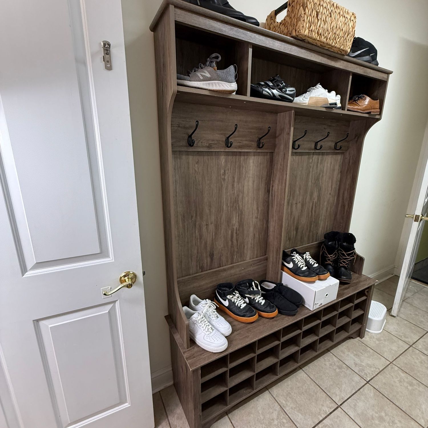 Tall hall tree bench with cubbies above and below, does have some wear, a few bumps to laminate, lower right front corner shows a bump and needs glued to stay in place 6'3"H x 16"D x 4'10"W