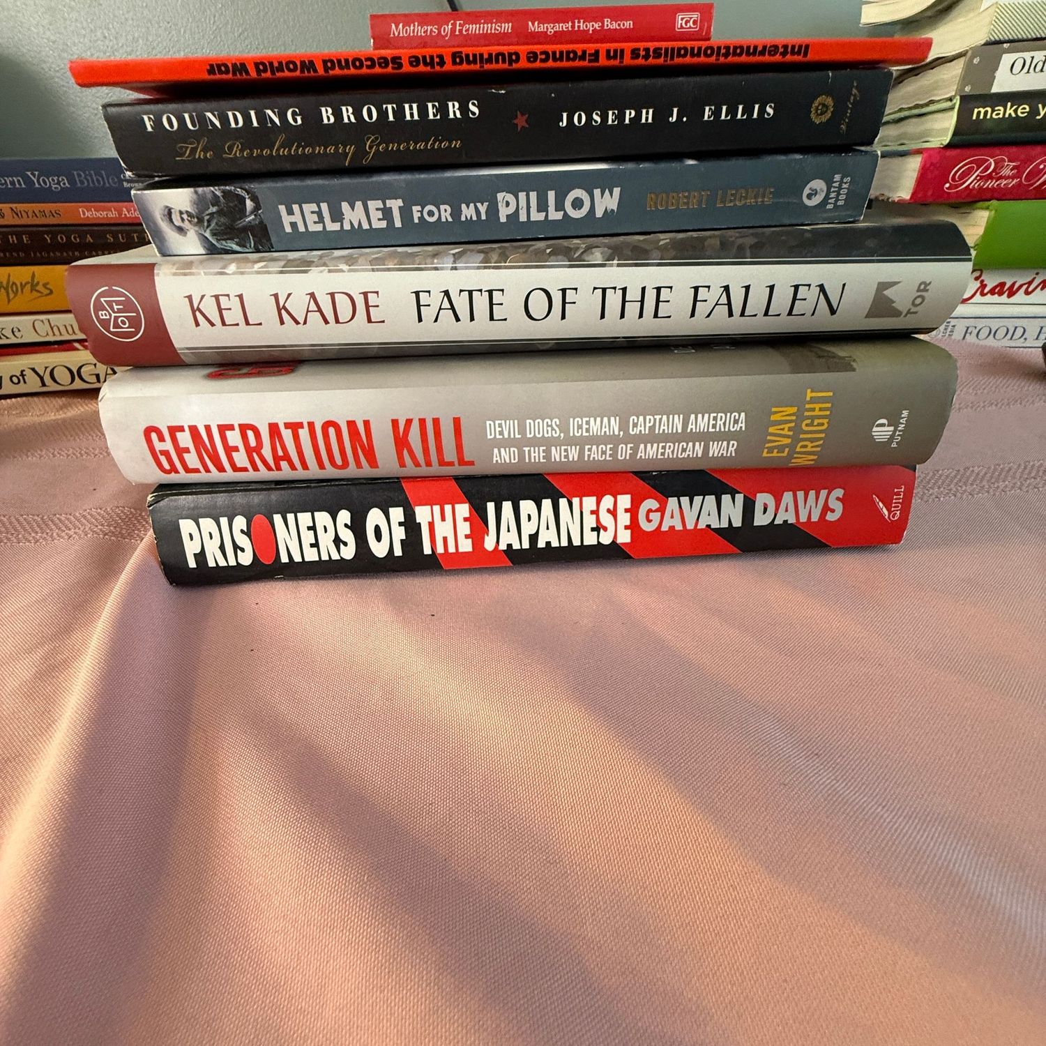 Group of books including Founding Brothers and Prisoners of the Japanese