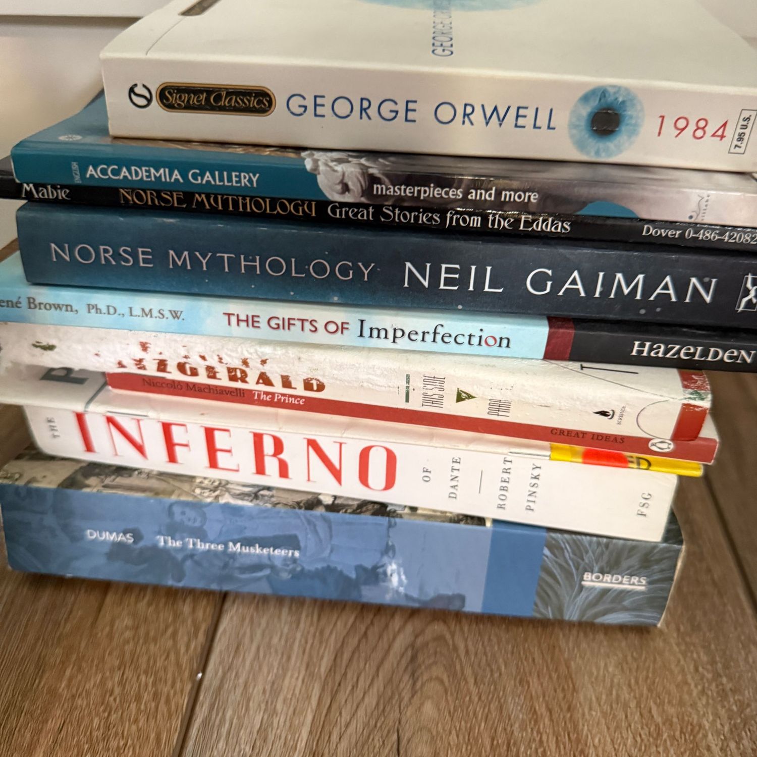 Group of books including Norse Mythology and Inferno