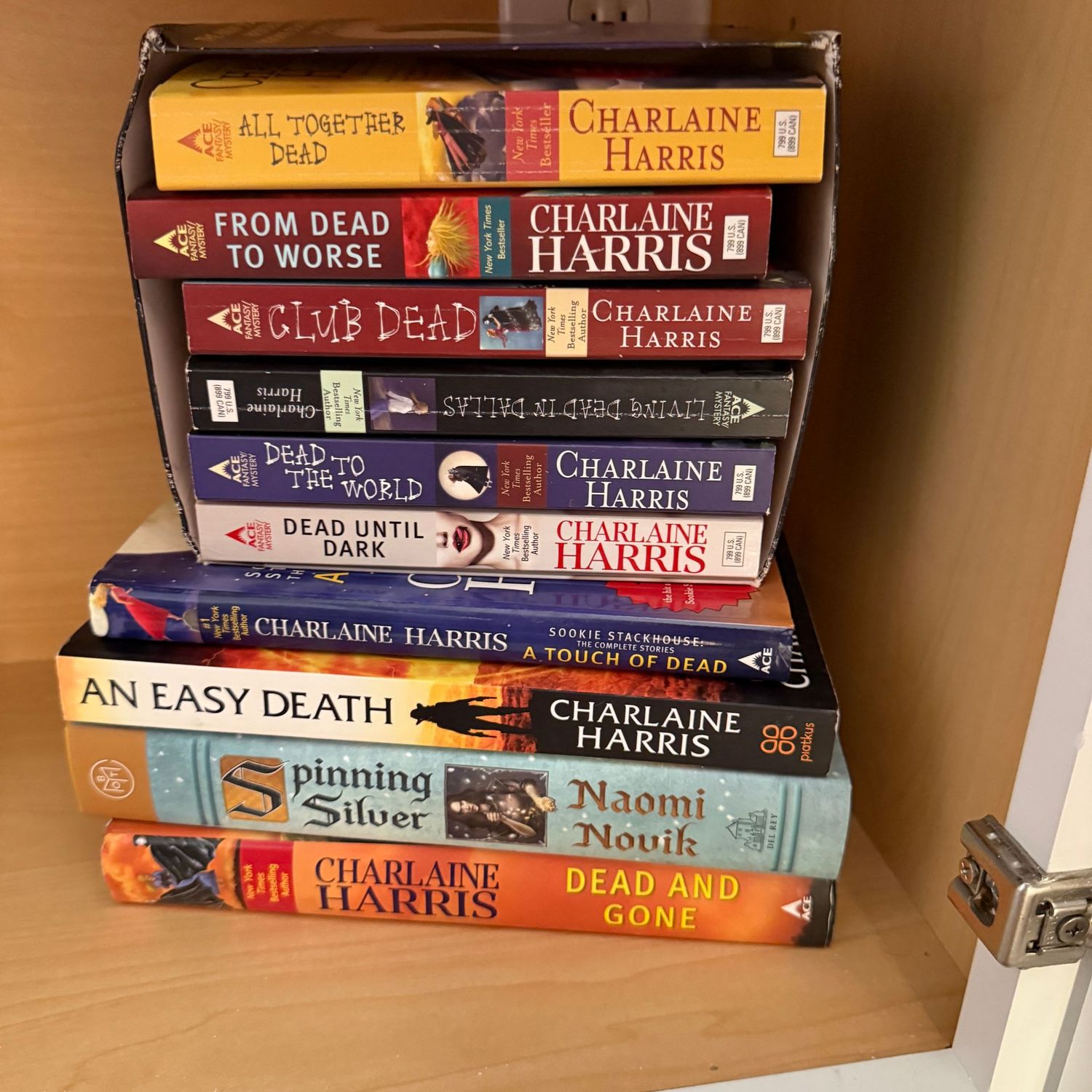 Group of books including All Together Dead by Charlaine Harris
