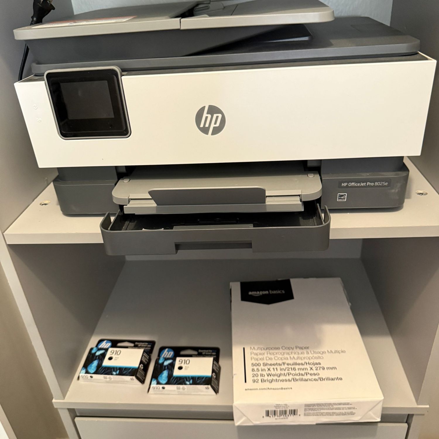 HP Office Jet Pro 8025e with ream of paper and ink cartridge