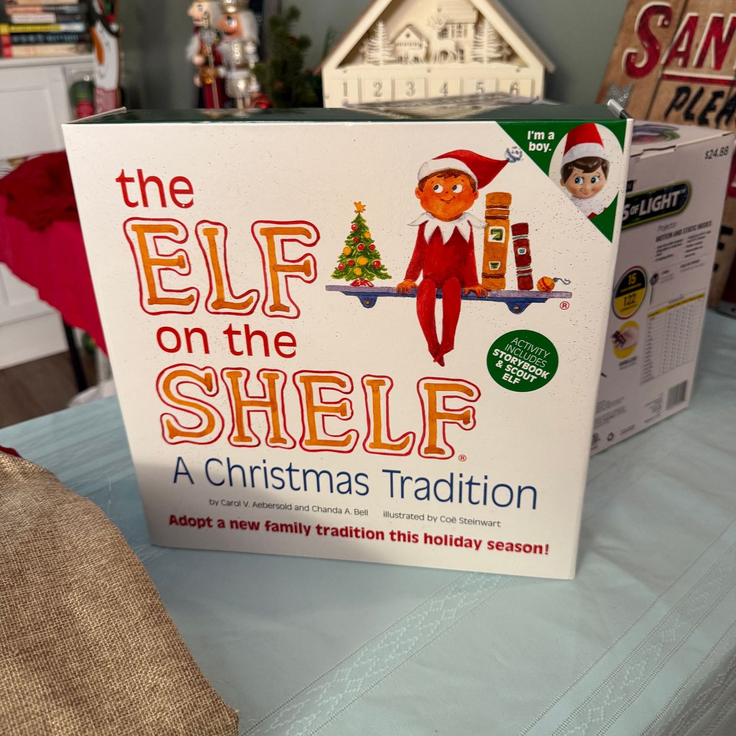 Elf on the Shelf, boy elf in package with book