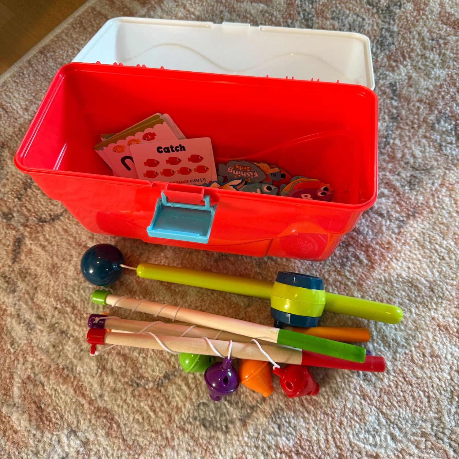 Box of small fishing toys and rods, may not be complete