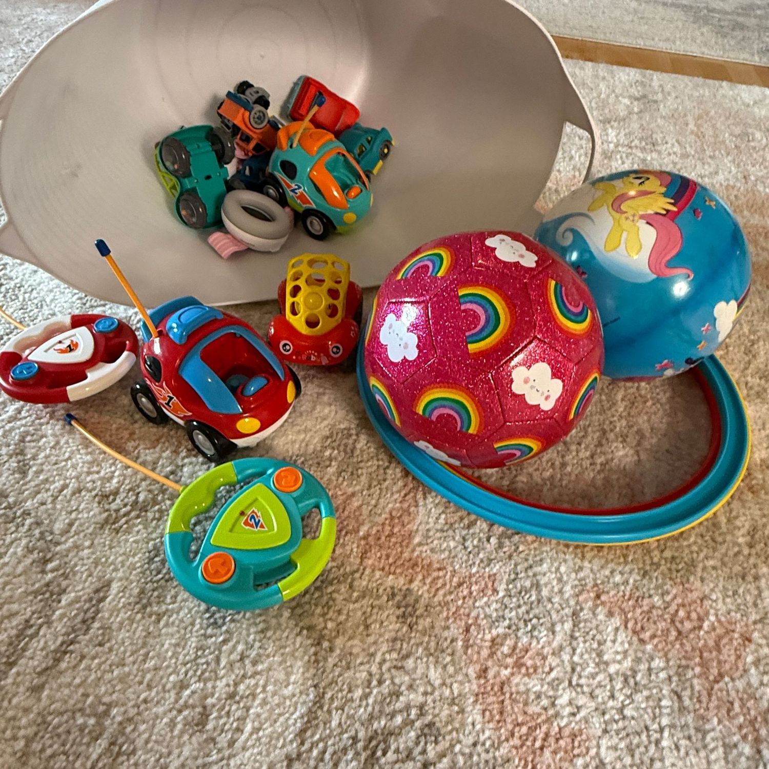Flexible white bin with battery-operated toy cars (not tested) balls and rings