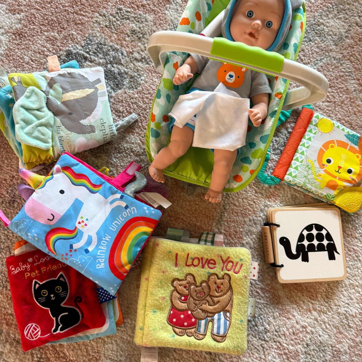 Baby doll in carrier with soft books