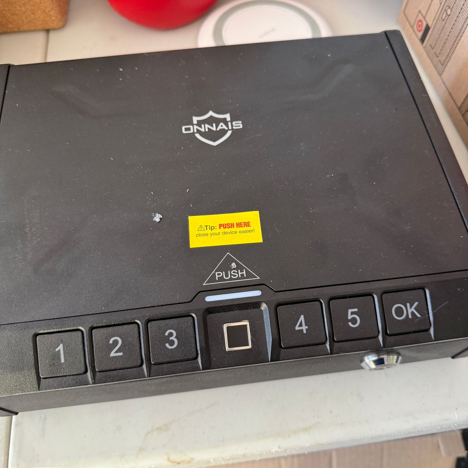 Onnais storage box, no key or code - but easy to reset after cracking open with a nail file, approx 10"W