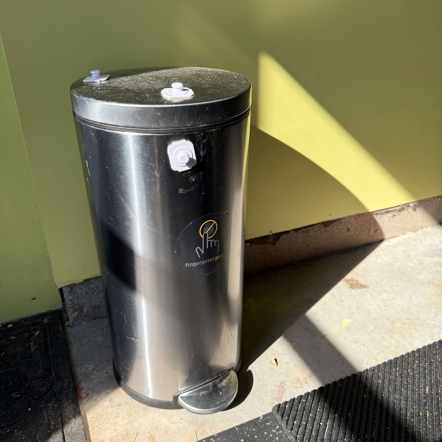Stainless slender round trash bin, kitchen size (GA) has a latch that could be removed with glue remover approx. 25"H