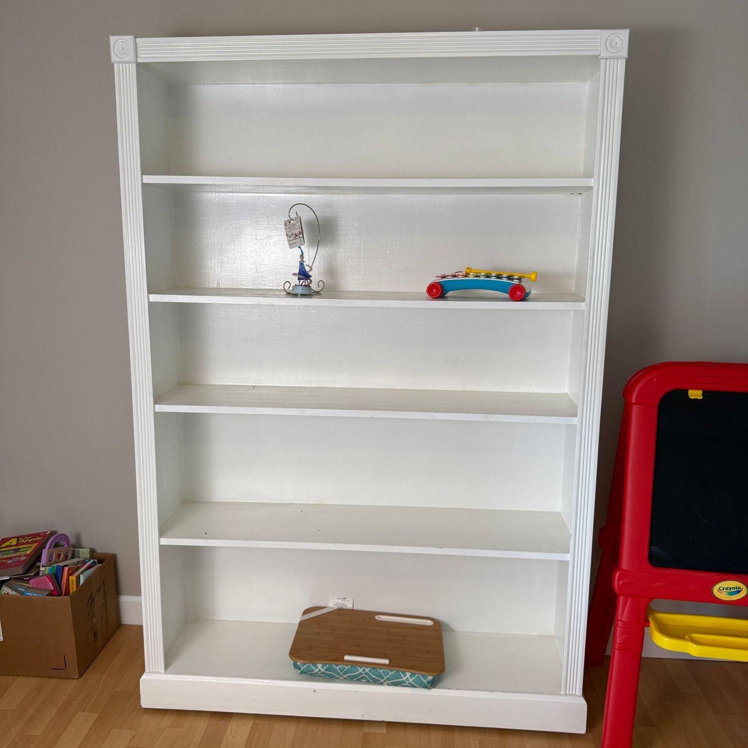 Tall white wooden bookshelf, has casters on front underneath 6'H x 13"D x 48"W (This item is upstairs)