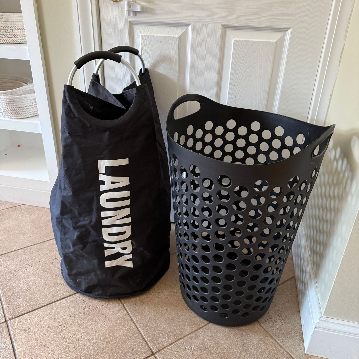 Two black laundry carriers, one tote with handles, and one plastic approx. 25"H
