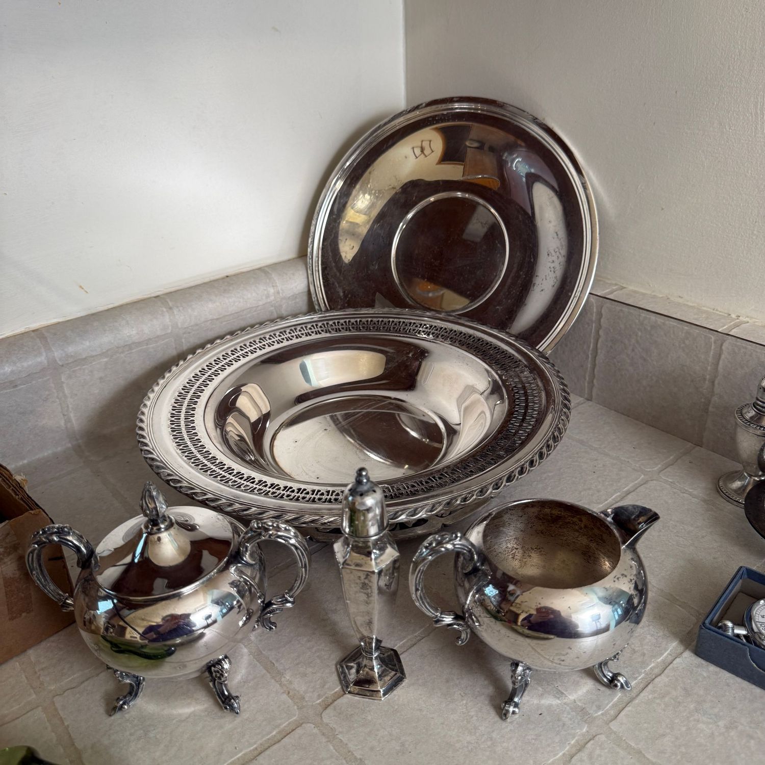 Group of silver-plated tableware with salt shaker, sugar, creamer, plate, and 11 Group of silver-plated tableware with salt shaker, sugar, creamer, plate, and 11" pierced dish