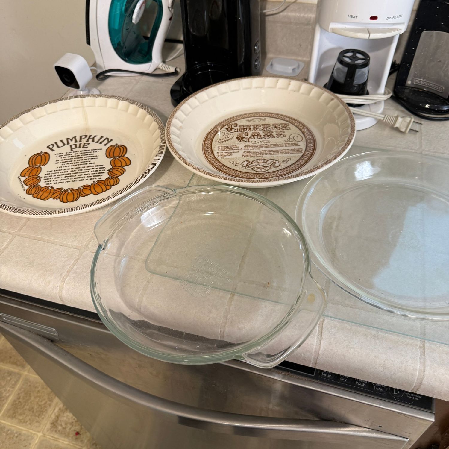 Pie pans, two clear glass, two with recipes (the pumpkin pie has a hairline crack) Pie pans, two clear glass, two with recipes (the pumpkin pie has a hairline crack)