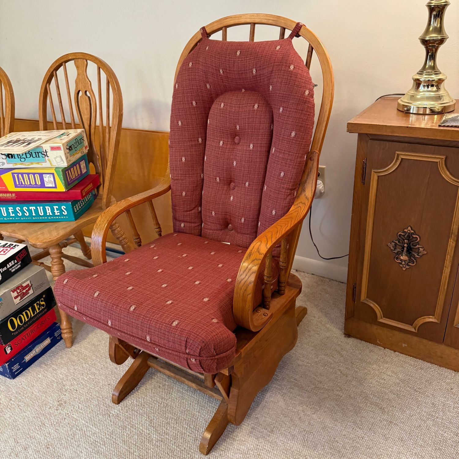 Glider rocker with dark red cushion, needs some spot cleaning Glider rocker with dark red cushion, needs some spot cleaning